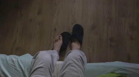 High angle view of a handsome man waking up and putting on slippers Video stock 59843005