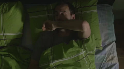 High angle view of a handsome man snoozing in bed in the morning Stock Footage 59843108