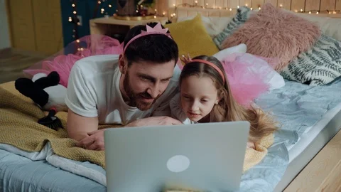 High angle view handsome man father and his daughter watching movies on laptop Stock Footage 112266473
