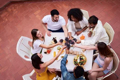 High angle view of happy group of friends toasting with red wine outside in a Stock Photos