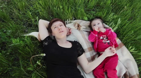 High angle view of happy mother and daughter resting in garden. Middle shot Stock Footage 50962998