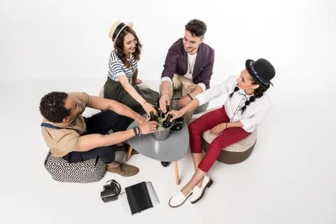 High angle view of happy young friends sitting together at table with beer bo Stock Photos