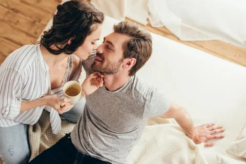 High angle view of happy young couple in love hugging while drinking coffee a Stock Photos