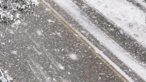 High angle view of heavy snowfall on a winter road Video stock 335955927