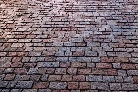 A high-angle view of a herringbone patterned brick pavement. Stock Photos
