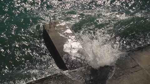 High angle view of high waves hitting the city beach shore. Stock Footage 79550204