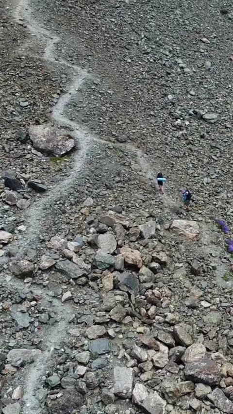 High angle view of hikers on zig zag trail on steep rocky scree slope Stock Footage 336691817