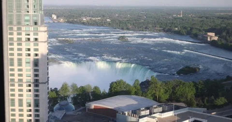 High angle view of Horseshoe Falls at Niagara with hotel rooftops and mist. Stock Footage 320025221