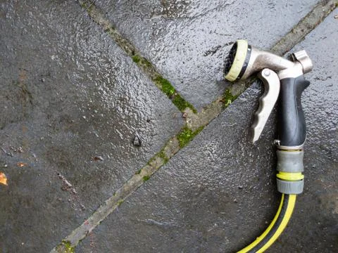 High angle view of hose nozzle on patio Stock Photos
