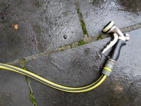 High angle view of hose nozzle on patio Stock Photos