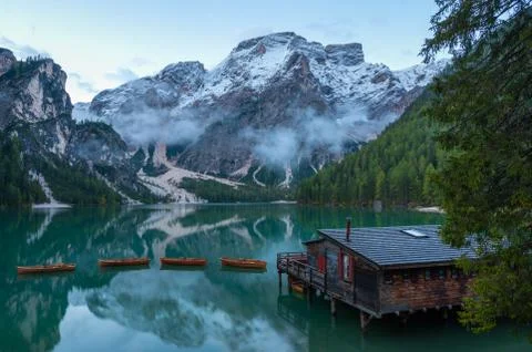 High angle view of iconic boathouse and boats with mount Seekofel mirroring i Stock Photos