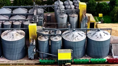 High-angle view of industrial grain silos and cargo train cars Stock Footage 336295349