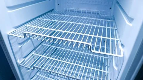 High angle view inside an empty refrigerator looking down from the left at .. Stock Photos
