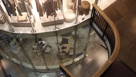 High-angle view inside a modern shopping mall with a cozy clothing display on th Stock Footage 305176250
