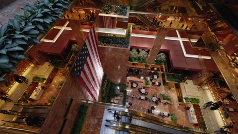 High-Angle View Inside Trump Tower Atrium with American Flag and Escalators Stock Footage 342427652