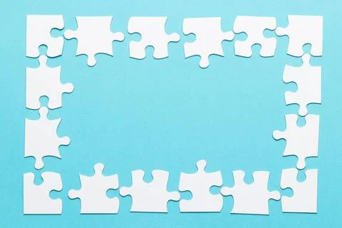 High angle view jigsaw puzzle frame blue backdrop 스톡 사진