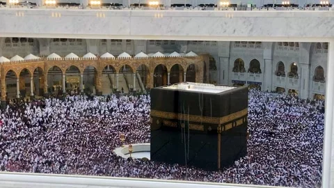 A high-angle view of the Kaaba in Mecca, Saudi Arabia, surrounded by a large Stock Footage 345835687