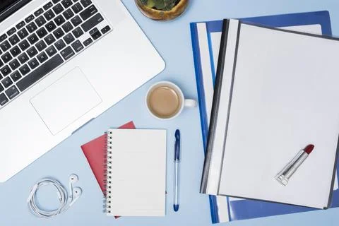 High angle view laptop folders coffee cup earphone spiral notepad pen again.. Stock Photos