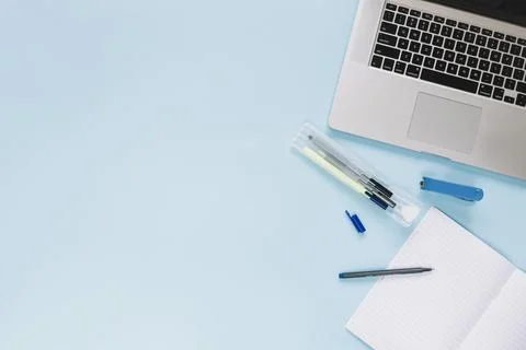High angle view laptop stationeries blue background Stock Photos