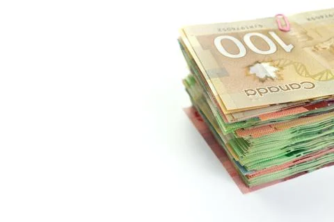 High Angle View of Large Stack of Canadian Banknotes on a White Background Stock Photos