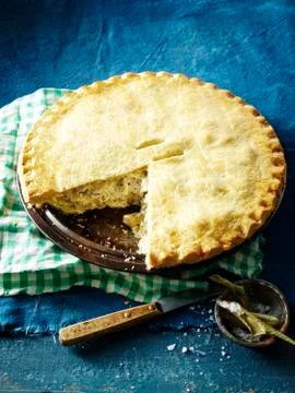 High angle view of lemon myrtle chicken pie, slice missing Stock Photos