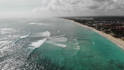 High angle view of light blue ocean water of Atlantic Ocean and a massive resort Stock Footage 154250456