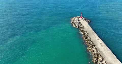 High Angle View With Lighthouse, Rocks And Sea Stock Footage 227923006