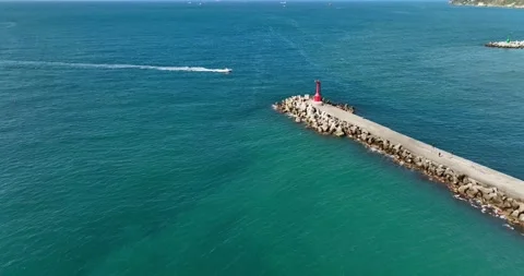 High Angle View With Lighthouse, Rocks And Sea Stock Footage 227924736