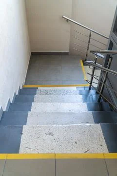 High angle view looking down concrete stairs featuring grey painted edges spe Stock Photos