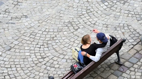 High angle view Lviv, Ukraine people couple sitting bench sound Stock Footage 97682899
