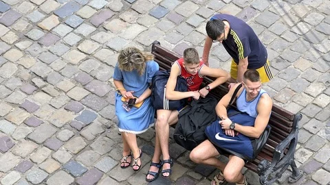 High angle view Lviv, Ukraine people family sitting bench sound Stock Footage 97682912