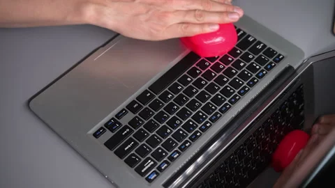 High-angle view of male hands using soft pink cleaning gel to remove dust, Video stock 342760820