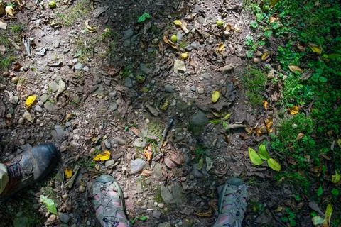 High angle view of an man and woman's feet on hiking trail Stock Photos