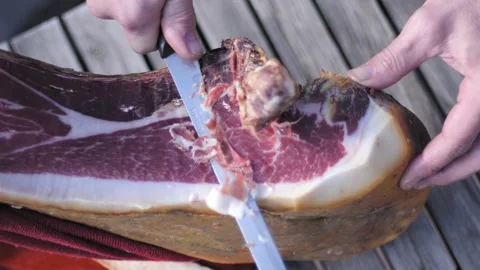 High angle view of man hand cutting a slice of dried spanish jamon serrano. 스톡 동영상 152247752