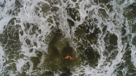 High angle view of man jogging on the beach. Drone Footage Stock Footage 105644990