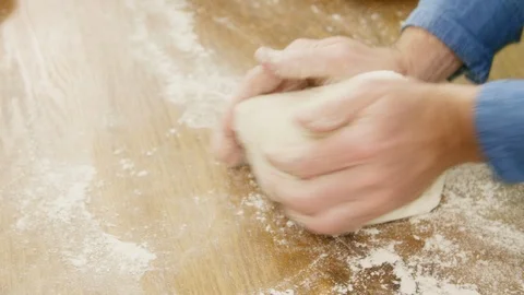 High Angle View Of Man Kneading Dough On Table Stock Footage 86075120