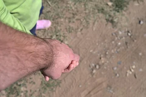 High angle view of a man's hand holding a child's hand. Father and child Stock Photos