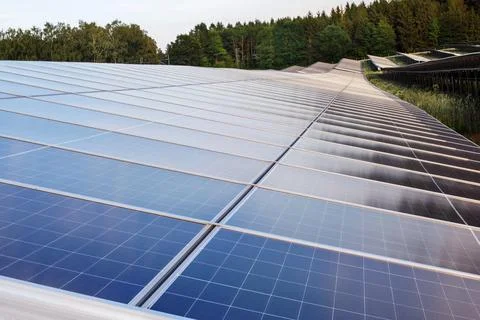 High angle view of massive rows of photovoltaic solar panels on a hillside po Stock Photos
