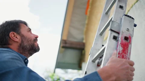 High angle view of mature man climbing up the ladder 스톡 동영상 177019737