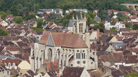 A high-angle view of the medieval church surrounded by traditional red-roofed Stock Footage 346699467