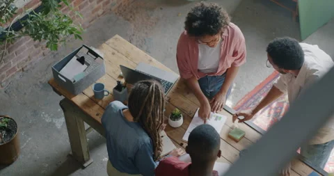 High angle view of men and women creative team working problem solving talking Stock-Footage 252013875