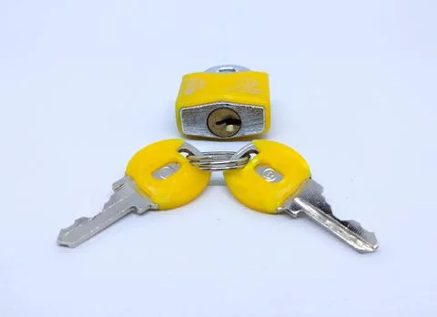 High Angle View Of Metallic Lock And Key Against White Background Stock Photos