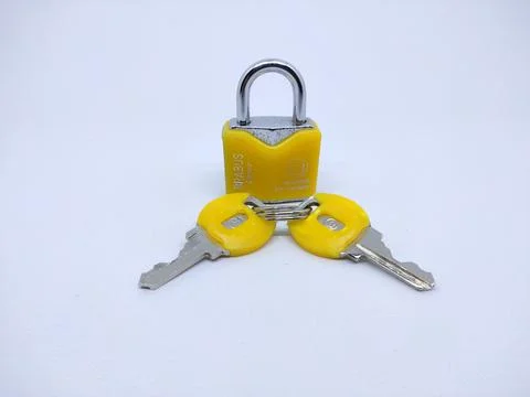 High Angle View Of Metallic Lock And Key Against White Background Stock Photos