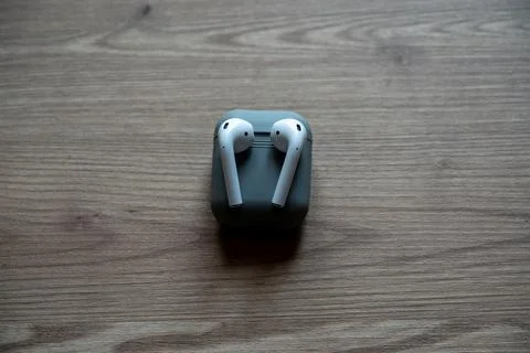 High angle view of minimalist wireless technology featuring white earbuds. Stock Photos