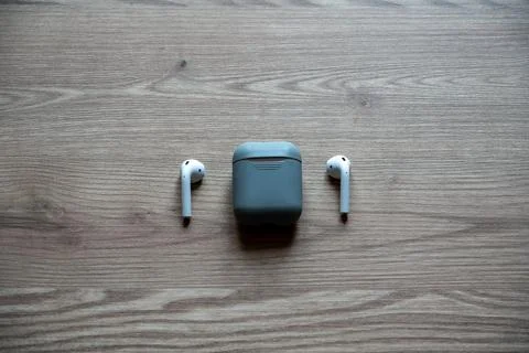 High angle view of minimalist wireless technology featuring white earbuds. Stock Photos