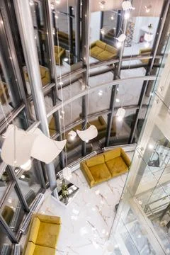 High angle view of modern atrium with glass walls and yellow sofas Stock Photos