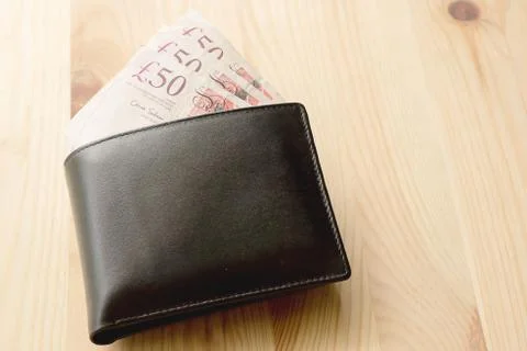 High Angle View Of Modern Black leather Men's Wallet With Pound Cash On The O Stock Photos