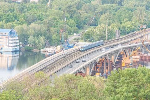 High angle view of a modern highway bridge over water, flanked by green tre.. Stock Photos