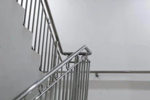 High-angle view of a modern stainless steel staircase railing against a mini Stock Photos