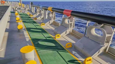 High angle view of mooring deck equipment with yellow bitts and pipe walkwa.. Stock-Fotos